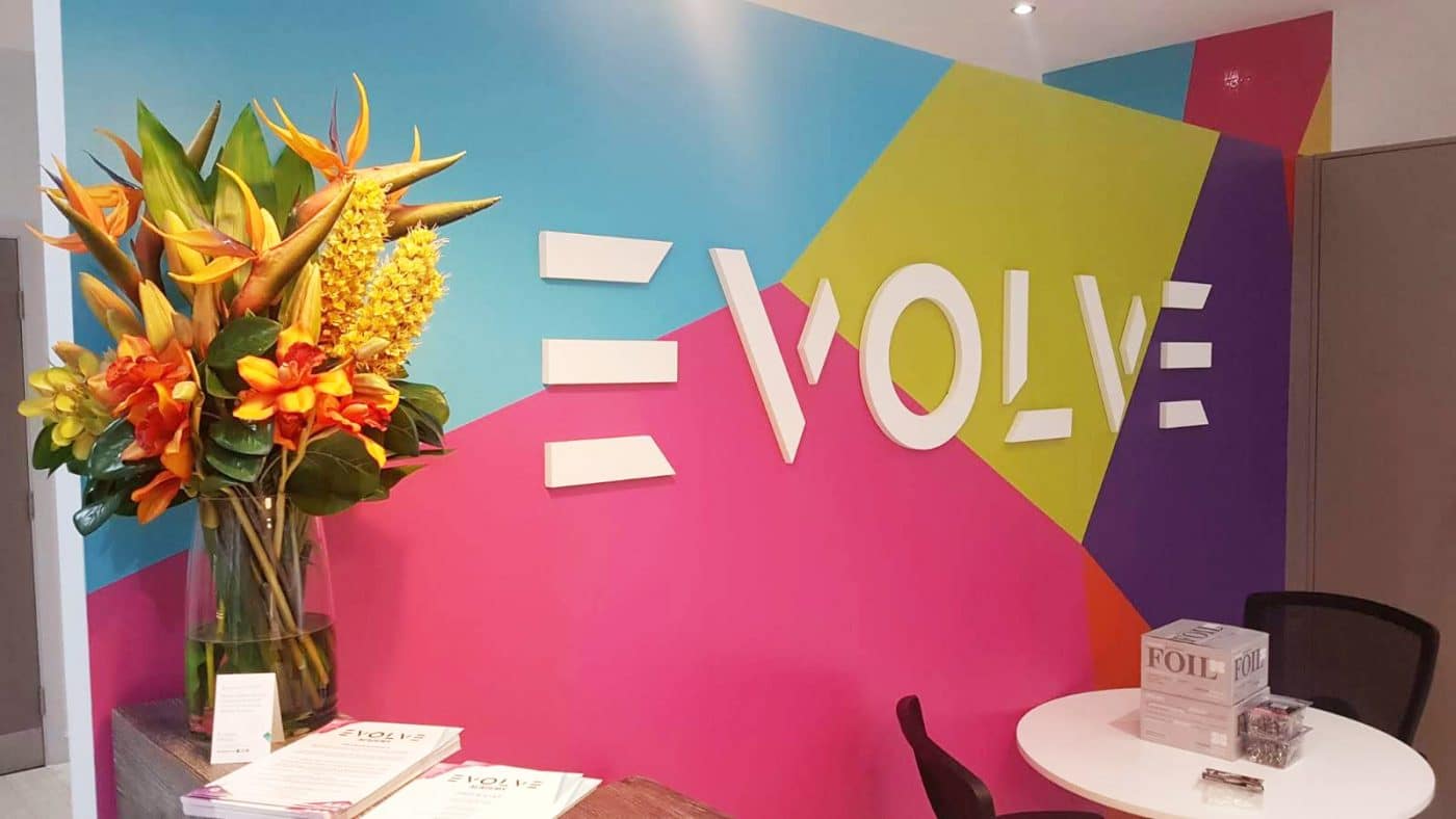 Flat cut branding and wallpaper feature at Evolve Academy.