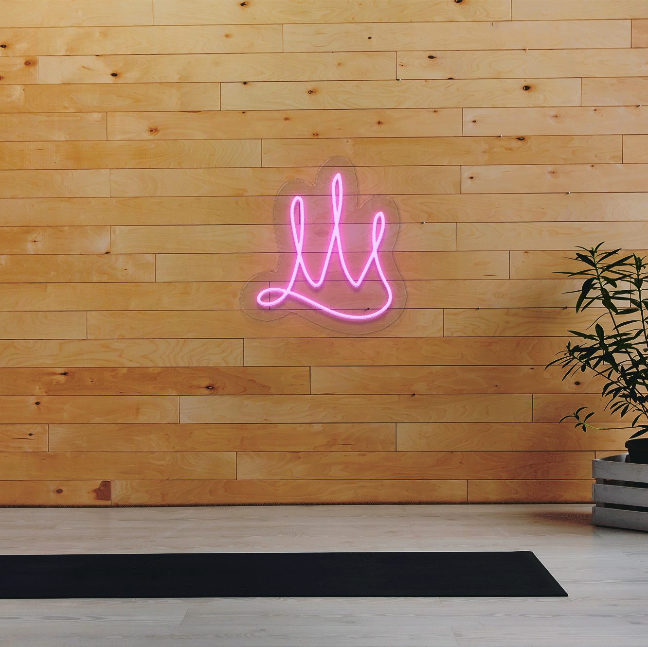 illuminated LED neon sign shown mocked up on wall with clear acrylic backing frame